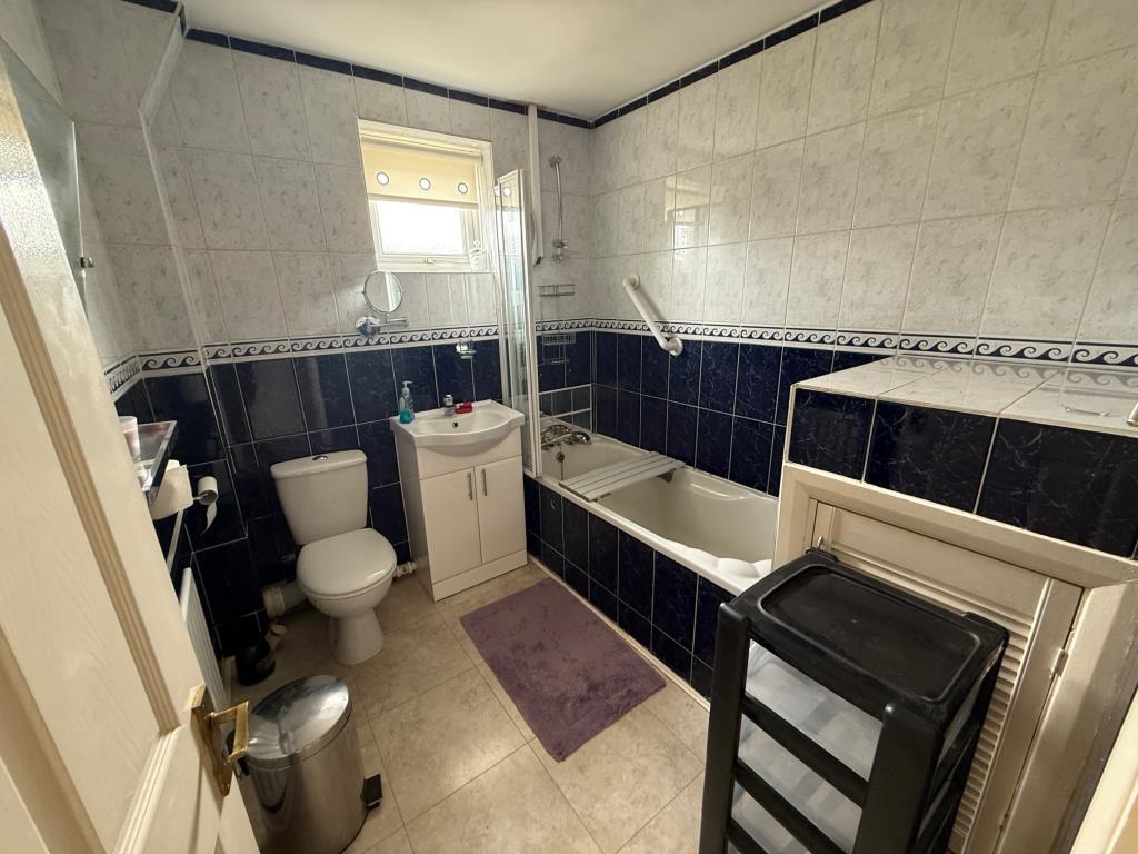 Lot: 111 - END-TERRACE ONE-BEDROOM HOUSE - Bath with shower over and w/c plus wash basin